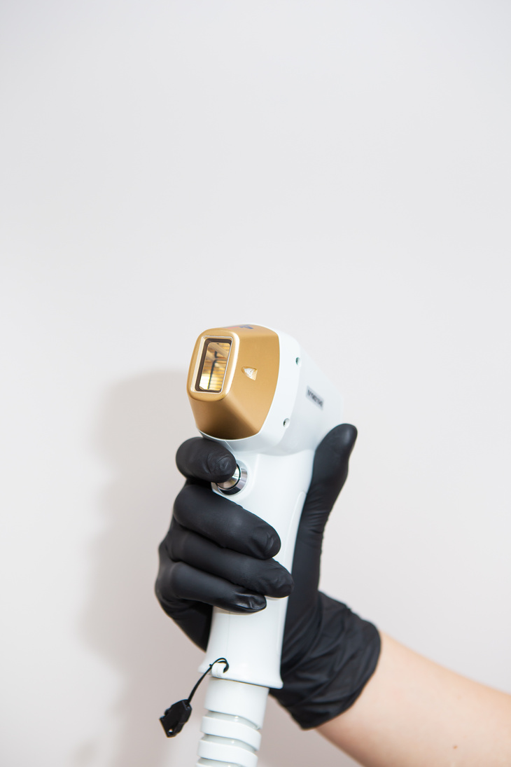 The Doctor Holds in His Hands a Device for Laser Hair Removal. the Concept of Skin Care, Hair Removal in the Spa Salon.
